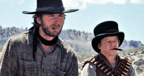 Image from High Plains Drifter showing two men overlooking a scene in nature